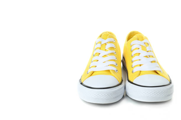 istock Pair of yellow sneakers isolated on white background 1495184186