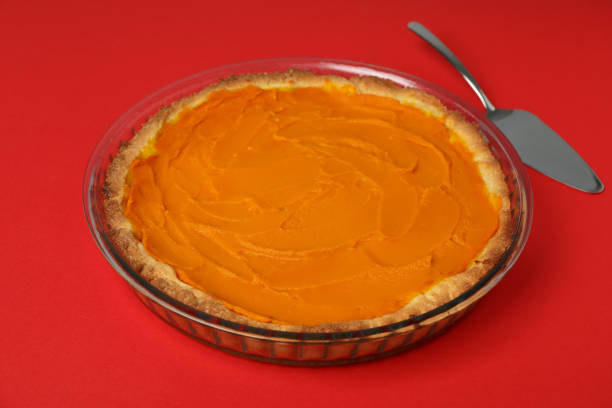 istock Pumpkin pie and cake spatula on red background 1495184515