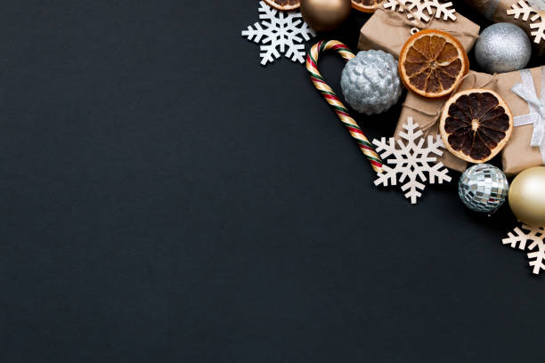 istock Beautiful Christmas golden silver decorations on a dark black background. Flat design, postcard, calendar, banner. Place for text. 1495186423