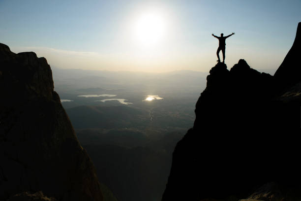 istock silhouette of brave and successful mountaineer on jagged cliffs 1495187700
