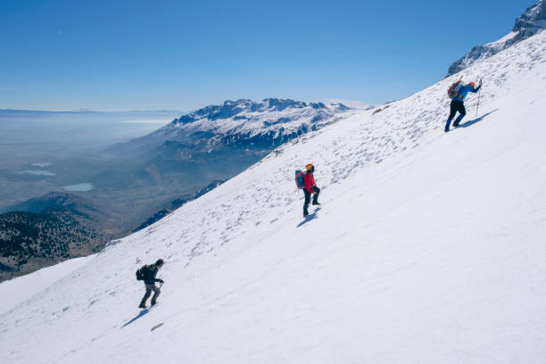 istock mountaineers climbing harmoniously on the steep and sloping summit 1495187890