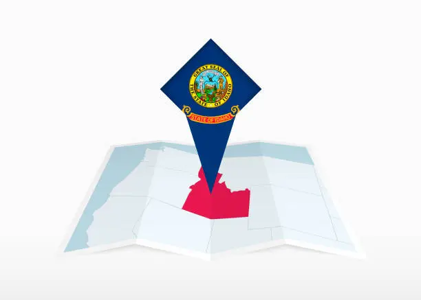 Vector illustration of Idaho is depicted on a folded paper map and pinned location marker with flag of Idaho.