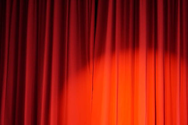 istock Red show curtain closed with spotlight shining on it 1495191767