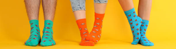 istock Legs in different socks on yellow background 1495194062