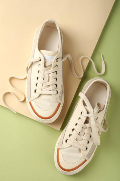 istock Pair of beige sneakers on two tone background 1495194130