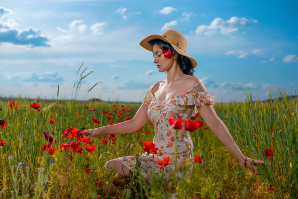 istock ung beauty walking in poppy field 1495197686