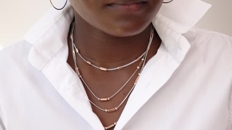 Unrecognizable fashionable African-American woman with necklaces around her neck