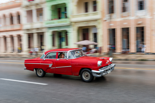 Havana, Cuba - October 21, 2017: Old Car in Havana, Cuba. Retro Vehicle Usually Using As A Taxi For Local People and Tourist. Panning Red Color Car