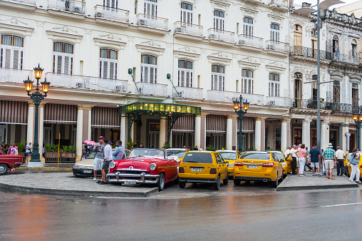 Havana, Cuba - October 21, 2017: Old Town in Havana, Cuba. Loca People and Architecture. Taxi in Foreground