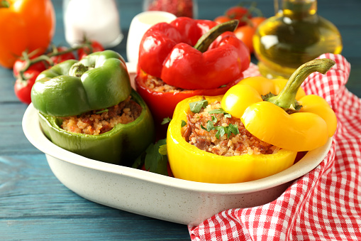 Concept of tasty food with ​stuffed pepper on wooden background