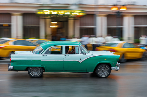 Havana, Cuba - October 21, 2017: Old Style Retro Car in Havana, Cuba. Public Transport Taxi Car for Tourist and Local People. Bright Green Color