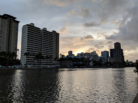 Oahu's Beautiful Ala Wai Canal at Sunset.The Ala Wai Canal is a man-made waterway that runs through the city of Honolulu on the island of Oahu. This panoramic photo shows the beauty and tranquility of this popular tourist destination.