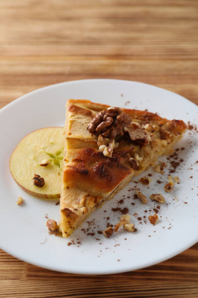 istock Piece of apple pie on plate on wooden background 1495204840