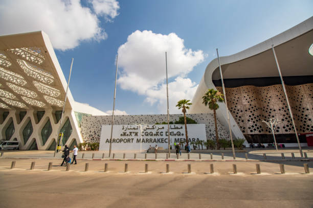 Marrakesh Menara Airport at Marrakesh-Safi, Morocco Incidental people near the place sign to Marrakesh Menara Airport at Marrakesh-Safi, Morocco marrakesh safi photos stock pictures, royalty-free photos & images