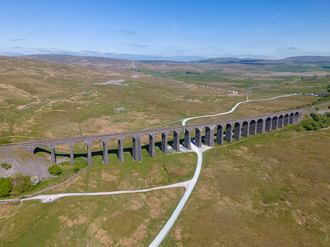 This aerial drone photo shows the Ribblehead railways viaduct in Yorkshire Dales National Park, England. The railway bridge is still being used by trains and was built in 1875.