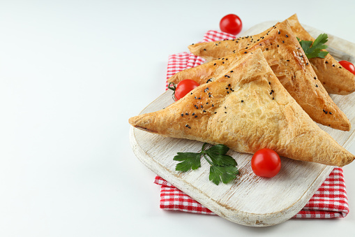 Concept of tasty food with samsa on white background