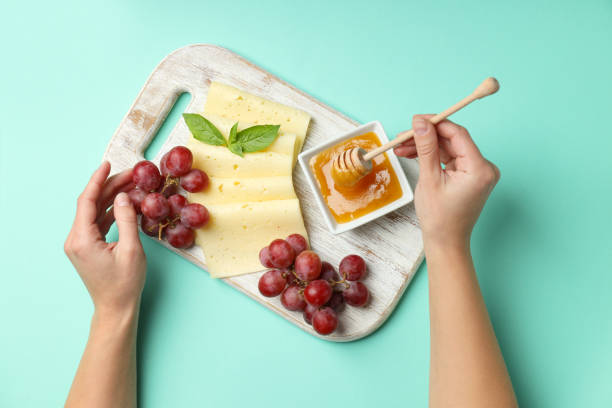 Concept of cooking eating with hard cheese on mint background