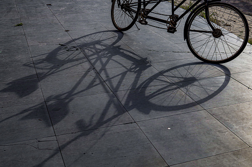 When this shadow is due to the morning sun.  An old bicycle.