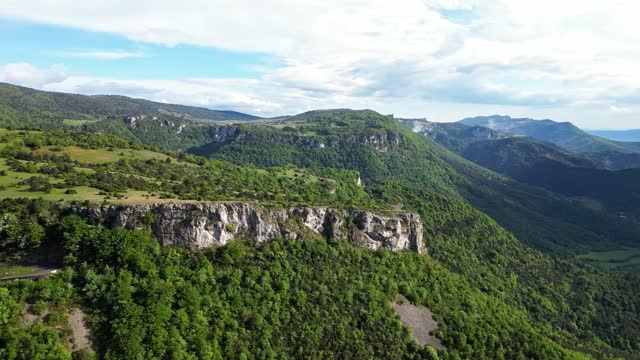 French countryside. Panoramic drone view of tree-covered hillsides of the heights of the Vercors, the marly hills and the valley Val de Drome, France