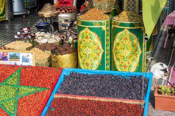 Moroccan Flag at Djemma el Fna Square in Marrakesh, Morocco Moroccan Flag shaped from argan nuts at Djemma el Fna Square in Marrakesh, Morocco. Commercial pictures are in the background. tivoli bazaar stock pictures, royalty-free photos & images