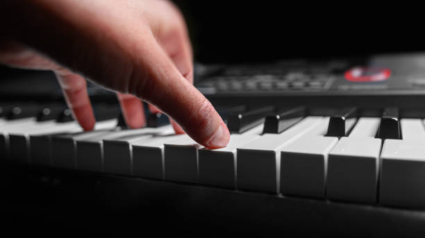 istock Playing the piano synthesizer on dark background 1495213200