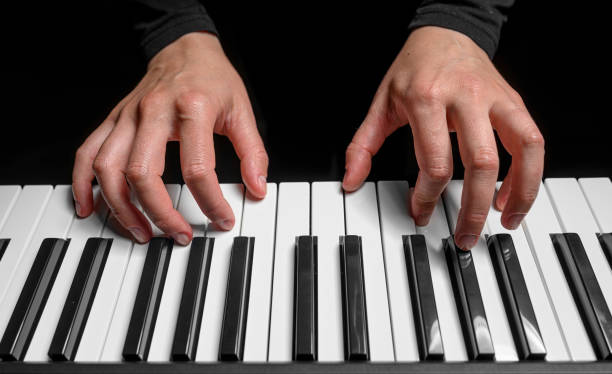 istock Playing the piano synthesizer on dark background 1495213204
