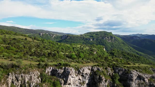 French countryside. Panoramic drone view of tree-covered hillsides of the heights of the Vercors, the marly hills and the valley Val de Drome, France