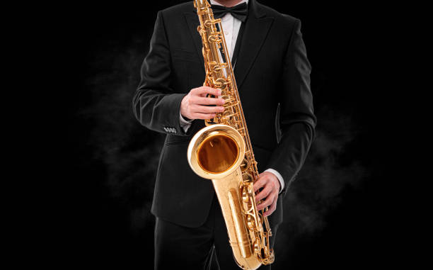 istock Saxophonist on a black background. 1495214491