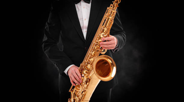 istock Saxophonist on a black background. 1495214509
