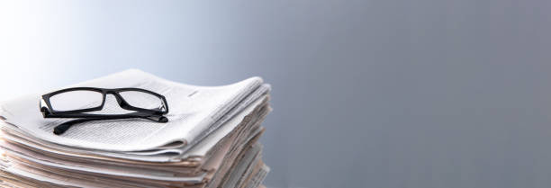 istock Pile of newspapers and optical glasses 1495217661