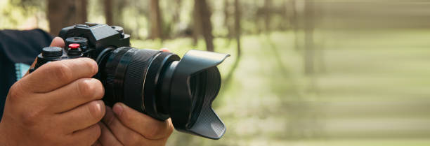 istock Holds a camera in his hand in the forest 1495217692