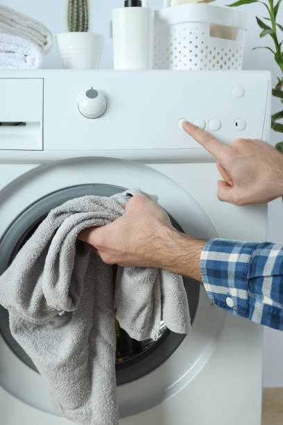 istock Concept of housework with washing machine and guy on white background 1495220222
