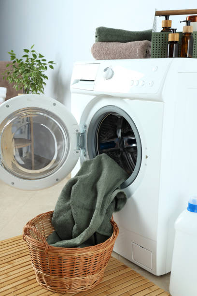 istock Concept of housework with washing machine against white wall 1495220289