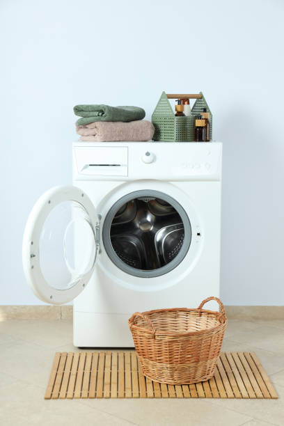 istock Concept of housework with washing machine against white wall 1495220821