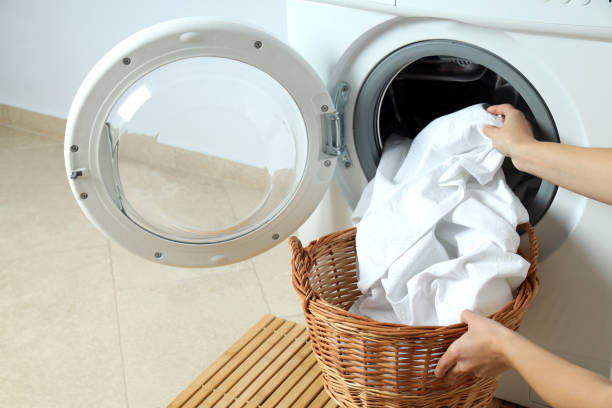 istock Concept of housework with washing machine against white wall 1495221420
