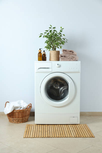istock Concept of housework with washing machine against white wall 1495221654