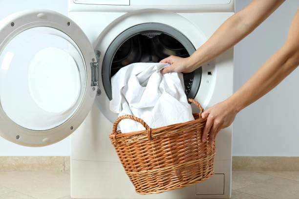 istock Concept of housework with washing machine against white wall 1495221717