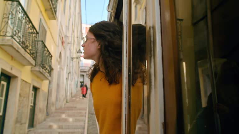 Young woman explore Lisbon from retro old tram