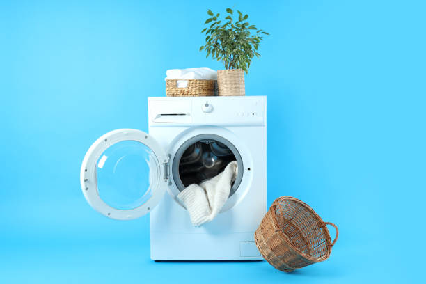 istock Concept of housework with washing machine on blue background 1495221904