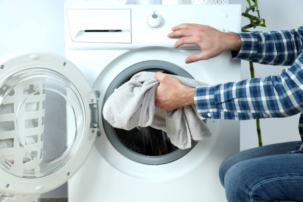 istock Concept of housework with washing machine and guy on white background 1495222082