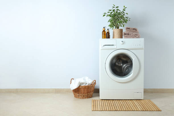 istock Concept of housework with washing machine against white wall 1495222657