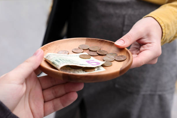 istock Client giving tips to waitress in outdoor cafe, closeup 1495224503