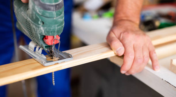 istock Work with an electric jigsaw - cutting wooden board close-up 1495224696