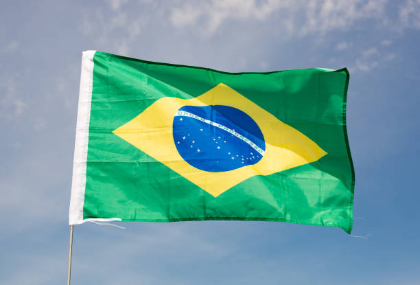 istock Brazil flag waving against blue sky 1495224716