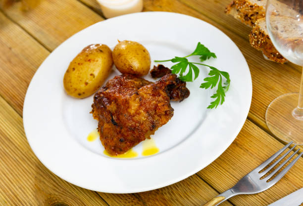 istock Baked shank and full potatoes in their jackets 1495224839
