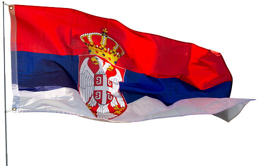 Serbian flag flying. Isolated over white background