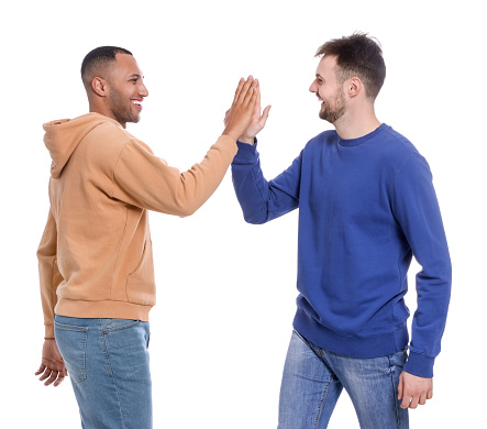 Men giving high five on white background