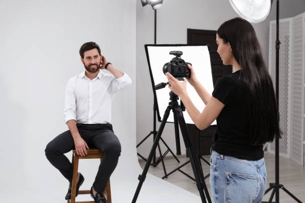 istock Professional photographer working with handsome model in modern photo studio 1495227182