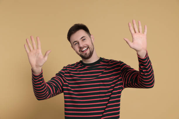 istock Man giving high five on beige background 1495227292