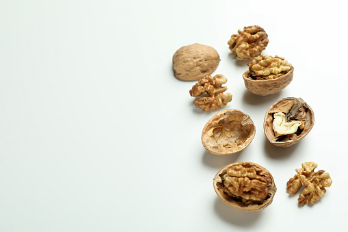 Flat lay composition with walnuts on white background